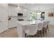 Bright white kitchen featuring a large island with seating, stainless steel appliances, and lots of cabinet space at 5410 Morey Farms Loop, Palmetto, FL 34221