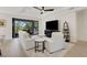 Cozy living room with a sliding glass door to outdoor patio, a ceiling fan, and lots of natural light at 5410 Morey Farms Loop, Palmetto, FL 34221