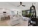 Sun-filled living room features modern furnishings, an open layout, and access to the lanai at 5410 Morey Farms Loop, Palmetto, FL 34221
