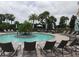Relaxing zero-entry pool featuring seating, lounge chairs, and lush landscaping at 5410 Morey Farms Loop, Palmetto, FL 34221