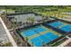 Aerial view of tennis and pickleball courts with lush landscaping and plenty of parking at 5410 Morey Farms Loop, Palmetto, FL 34221