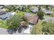 Aerial view of a home with a brown roof, attached two-car garage, driveway, and mature landscaping at 5507 Nimitz Rd, New Port Richey, FL 34652