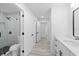 Stylish bathroom featuring a glass enclosed shower with black fixtures and hardware, plus gray vinyl floors at 5507 Nimitz Rd, New Port Richey, FL 34652