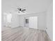 Bright bedroom with modern flooring and a sliding glass door to the screened-in patio at 5507 Nimitz Rd, New Port Richey, FL 34652