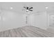 Comfortable bedroom with a ceiling fan, a double door closet, and light gray vinyl floors at 5507 Nimitz Rd, New Port Richey, FL 34652