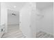 Hallway with closet leads into a modern bathroom and bedroom at 5507 Nimitz Rd, New Port Richey, FL 34652