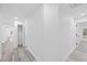 Bright hallway with modern flooring leads to various rooms in the home at 5507 Nimitz Rd, New Port Richey, FL 34652