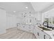 Spacious kitchen features an island with stone countertops, modern appliances, and white cabinets at 5507 Nimitz Rd, New Port Richey, FL 34652