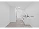 Well-lit laundry room features stainless steel sink, white cabinets, and modern flooring at 5507 Nimitz Rd, New Port Richey, FL 34652