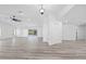Bright and open living room with recessed lighting, ceiling fan, sliding glass doors to lanai, and wood-look flooring at 5507 Nimitz Rd, New Port Richey, FL 34652