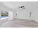 Main bedroom featuring modern flooring and a sliding glass door to a screened-in patio and pool at 5507 Nimitz Rd, New Port Richey, FL 34652