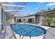 Enclosed pool with blue tile surrounded by a white deck and featuring handrails at 5507 Nimitz Rd, New Port Richey, FL 34652
