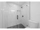 Modern shower featuring marble look tile with black hardware, a black shower head, and black framed glass at 5507 Nimitz Rd, New Port Richey, FL 34652