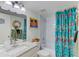 Bathroom features granite countertops, decor, and a shower/bath combo with a floral curtain at 5849 Park N St # 412, St Petersburg, FL 33709