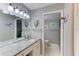 Bathroom featuring granite countertops, decor, and access to the shower at 5849 Park N St # 412, St Petersburg, FL 33709