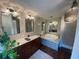 Bright bathroom with a double sink vanity, soaking tub, and tiled walk-in shower at 6036 110Th N Ave, Pinellas Park, FL 33782