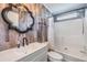 Bathroom featuring a modern sink, faucet, and stylish mirror above the toilet and tiled shower at 6036 110Th N Ave, Pinellas Park, FL 33782