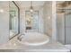 Bathroom featuring an oval soaking tub, tiled shower, and modern fixtures at 6036 110Th N Ave, Pinellas Park, FL 33782