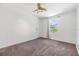 Empty bedroom with neutral carpet, white walls, and ceiling fan at 6036 110Th N Ave, Pinellas Park, FL 33782