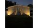 Well-lit home exterior featuring clean lines and shadow plants, enhancing the property's nighttime curb appeal at 6036 110Th N Ave, Pinellas Park, FL 33782