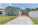 Charming single-story home featuring a well-maintained lawn and welcoming walkway leading to a covered entry at 6036 110Th N Ave, Pinellas Park, FL 33782