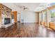 Bright living room with fireplace, hardwood floors, and large windows overlooking backyard at 6036 110Th N Ave, Pinellas Park, FL 33782