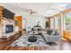 Bright living room featuring hardwood floors, a stone fireplace, skylights, and comfortable seating at 6036 110Th N Ave, Pinellas Park, FL 33782