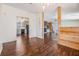 Open floor plan with wood flooring leading to the kitchen, dining area, and living spaces at 6036 110Th N Ave, Pinellas Park, FL 33782