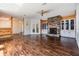 Open-concept living space with hardwood floors, stone fireplace, and ample natural light at 6036 110Th N Ave, Pinellas Park, FL 33782
