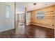 Open living area with wood-look flooring, wood paneling, and lots of light at 6036 110Th N Ave, Pinellas Park, FL 33782