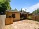View of the back exterior of the home with stone paver patio and fenced backyard at 6201 Amaretto Ln # 6201, Tampa, FL 33634