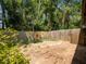 Backyard patio with wood fence painted with sunflowers, trees in background at 6201 Amaretto Ln # 6201, Tampa, FL 33634