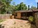 View of the back exterior of the home with stone paver patio and fenced yard at 6201 Amaretto Ln # 6201, Tampa, FL 33634
