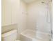 Bathroom including shower over tub and white tile at 6201 Amaretto Ln # 6201, Tampa, FL 33634