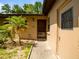Inviting front door with a storm door, complemented by a lush landscaping at 6201 Amaretto Ln # 6201, Tampa, FL 33634