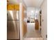 Bright hallway with stainless steel refrigerator and living room with fireplace and skylight beyond at 6201 Amaretto Ln # 6201, Tampa, FL 33634