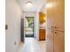 Hallway and entry featuring tile floors with a view of the front yard and cabinet storage at 6201 Amaretto Ln # 6201, Tampa, FL 33634