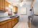 Well-lit kitchen with wooden cabinets, gray countertops and modern stainless steel appliances at 6201 Amaretto Ln # 6201, Tampa, FL 33634