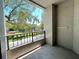 Balcony featuring wrought iron railing overlooking a beautiful lake and mature trees at 622 Seascape Way, Tampa, FL 33602