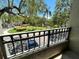 Beautiful balcony view with wrought iron railing overlooking a picturesque lake, lush landscaping, and fountain at 622 Seascape Way, Tampa, FL 33602