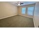 Bedroom with olive carpeting, two sunny windows, and a ceiling fan at 622 Seascape Way, Tampa, FL 33602