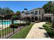 Image of the community clubhouse featuring a pool area and meticulous landscaping visible from a paved walkway at 622 Seascape Way, Tampa, FL 33602