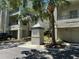 Exterior view of building with mailbox in foreground surrounded by palm trees and other tropical landscaping at 622 Seascape Way, Tampa, FL 33602