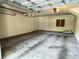 Spacious two car garage with automatic door system with overhead lighting and painted white walls at 622 Seascape Way, Tampa, FL 33602
