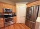 Kitchen featuring stainless steel appliances, wooden cabinetry, and wood flooring at 622 Seascape Way, Tampa, FL 33602