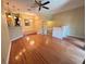 Open-concept living room featuring hardwood floors, a ceiling fan, and adjacent dining area, offering a bright and airy atmosphere at 622 Seascape Way, Tampa, FL 33602