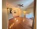 Open-concept living room featuring hardwood floors, a ceiling fan, and adjacent dining area, offering a bright and airy atmosphere at 622 Seascape Way, Tampa, FL 33602