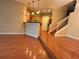 View of the kitchen and stairs from the living room, featuring hardwood floors and an open floor plan at 622 Seascape Way, Tampa, FL 33602