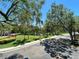 Scenic view of tree-lined street with lush landscaping, community fountain, and manicured grounds on a bright, sunny day at 622 Seascape Way, Tampa, FL 33602