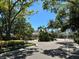 View of neighborhood entrance road, lined with mature trees and manicured landscaping at 622 Seascape Way, Tampa, FL 33602